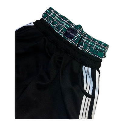 Pantalon jogging noir à bandés avec short à carreaux intégré